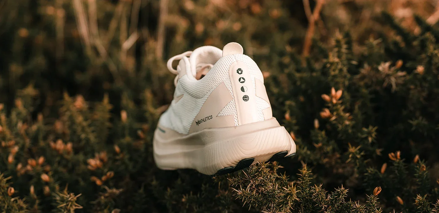 A white hylo shoe resting in dry grass